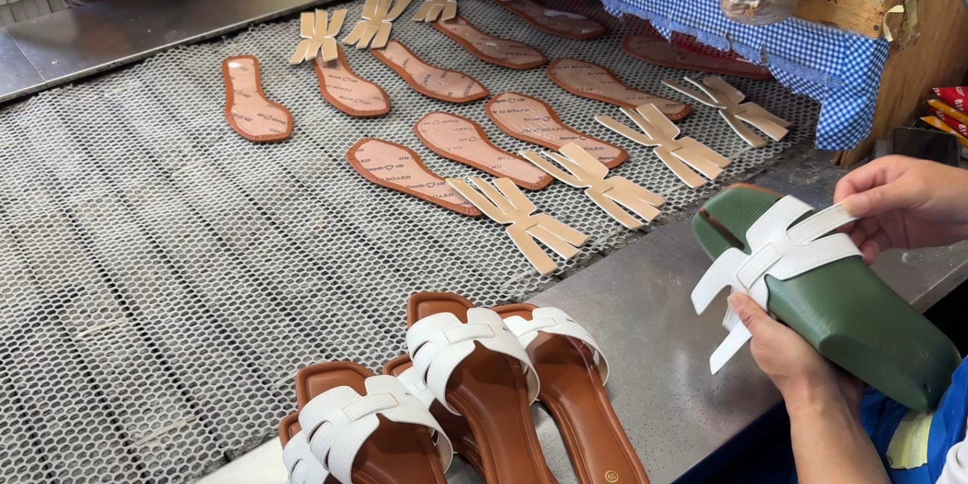 Sandals being hand-assembled on production line